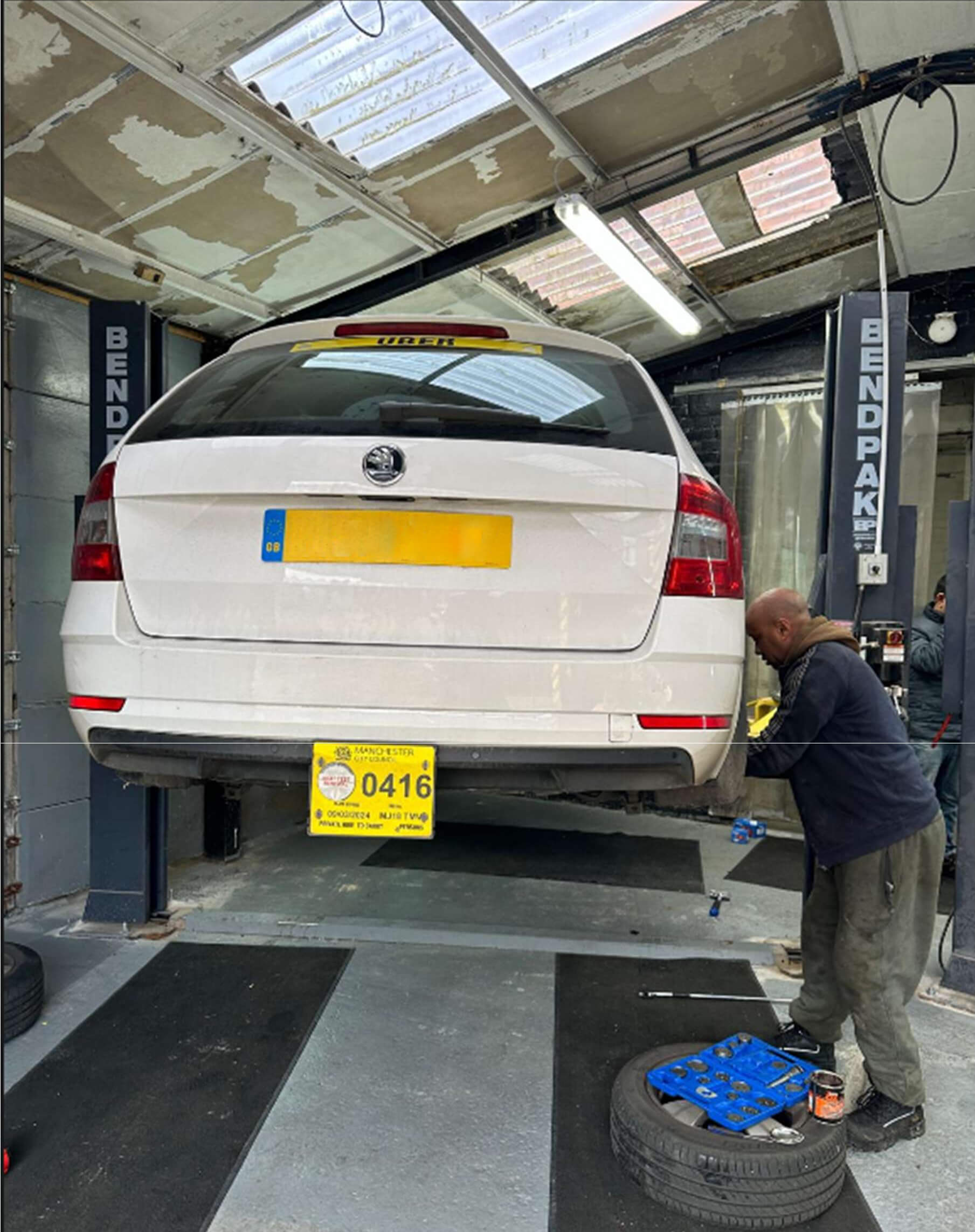 A mechanic working on a car